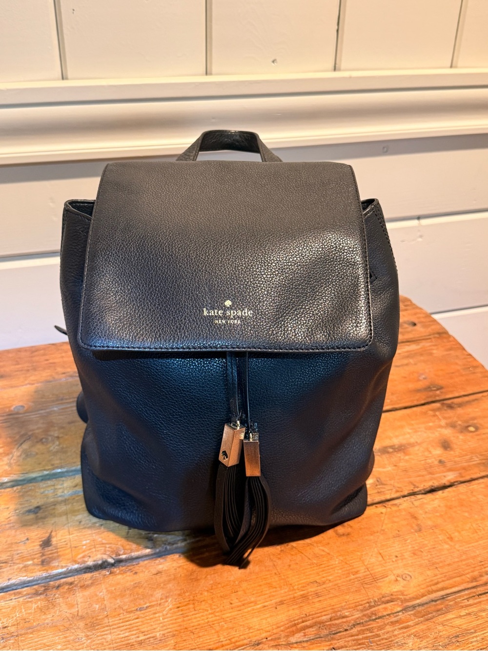 Kate Spade New York Black Pebbled Leather Flap Drawstring Backpack